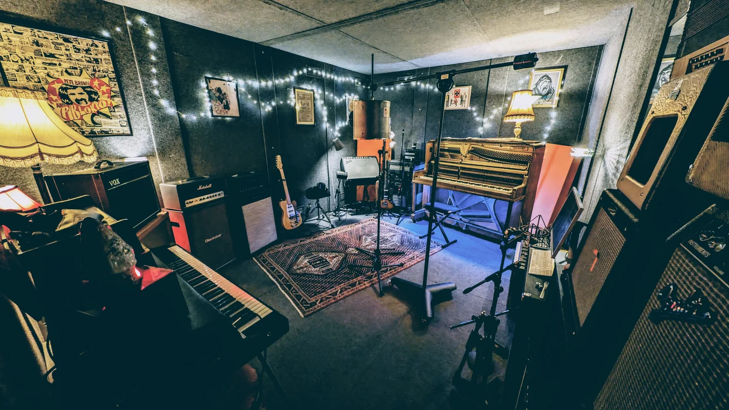 The live room with piano, amplifiers, keyboards and microphones