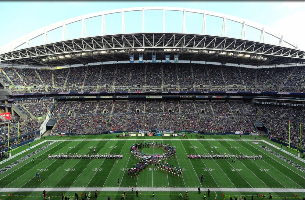 On field celebration of cancer survivors form CHI Franciscan and Virginia Mason at Seattle Seahawks’ Crucial Catch game.