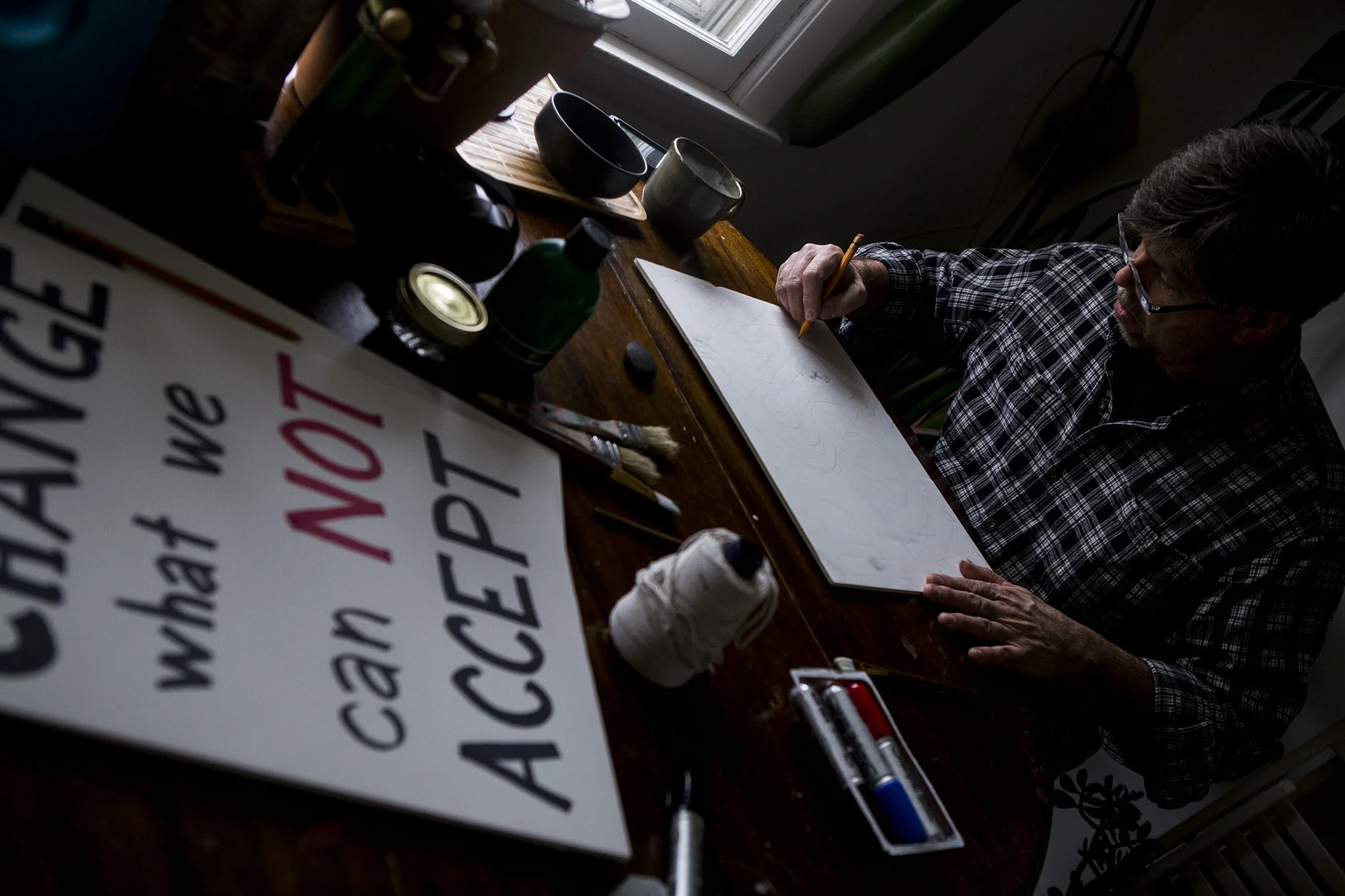 Man makes signs for women's march.