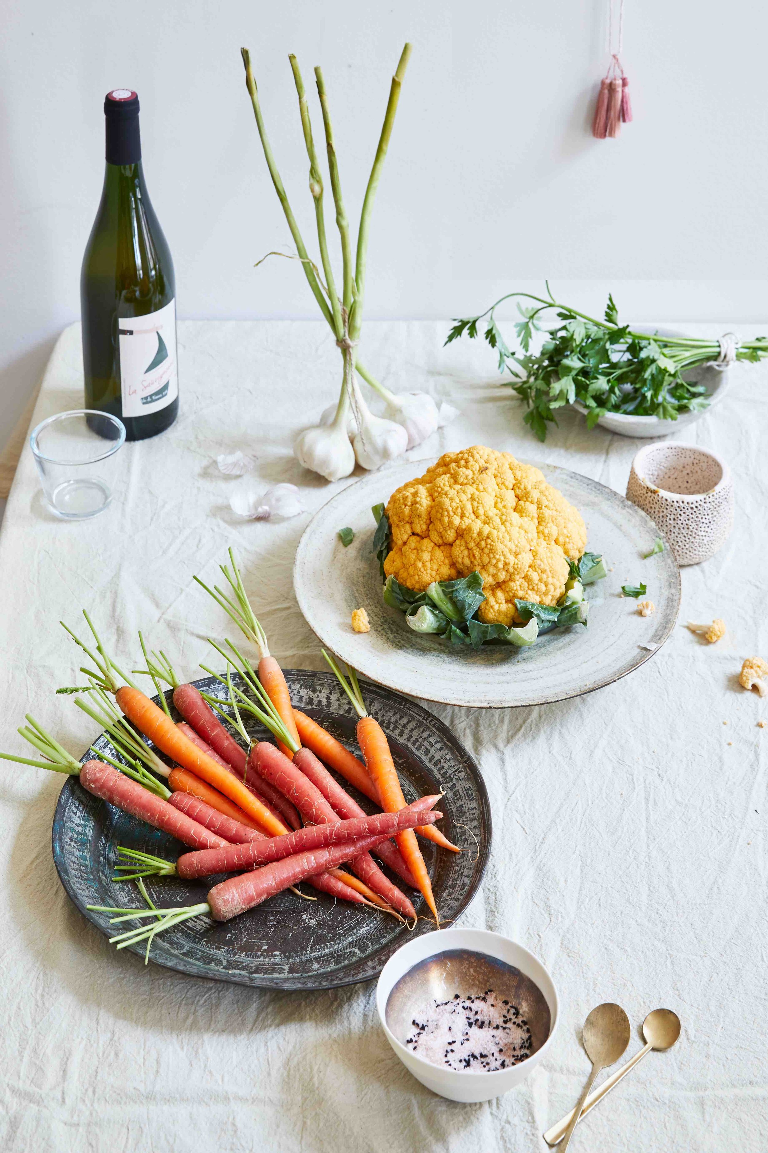 organic table setting with white linen, raw veggies and natural wine.jpg
