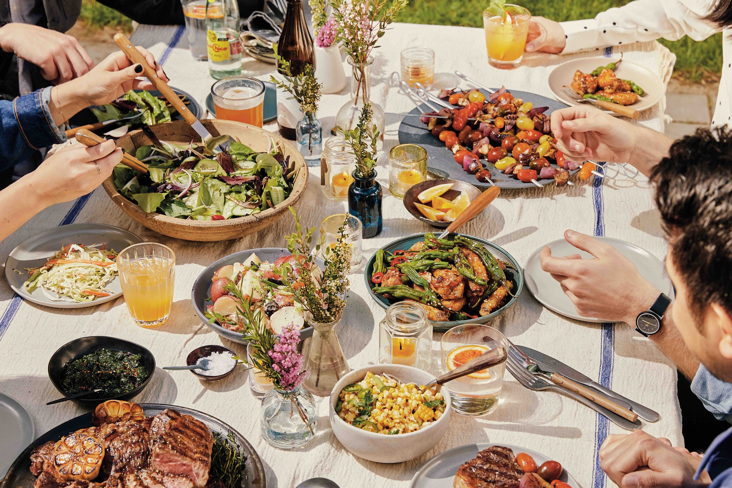 summer bbq backyard with friends eating steak and grilled veggies in brooklyn.jpg