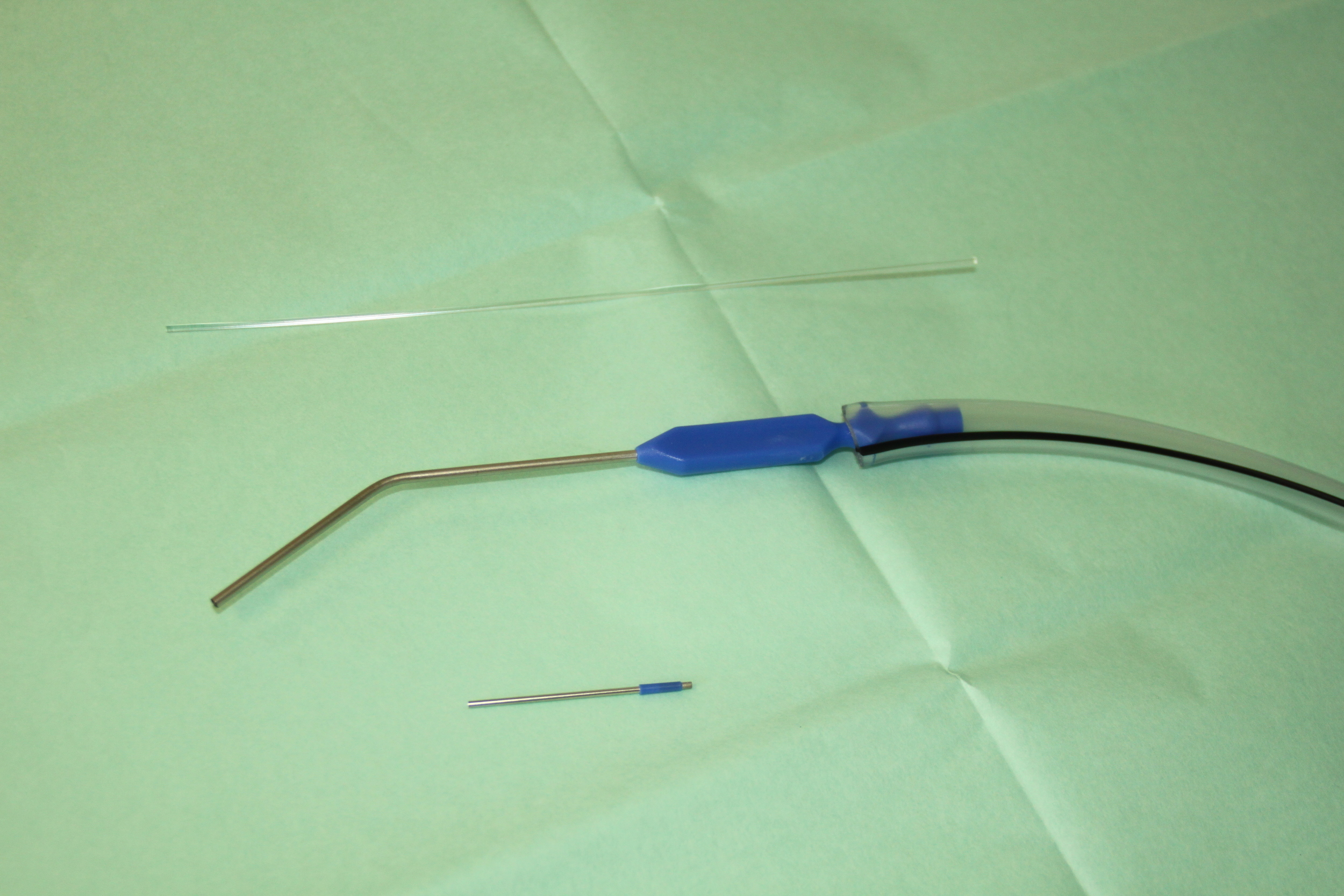 Above: A Zoellner catheter attached to suction tubing; below it is a small 'fine end' used for finer work