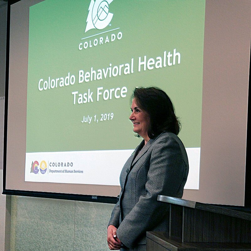 Commissioner Lora Thomas welcomes partners from across the state to the Colorado Behavioral Task Force meeting, July 2019