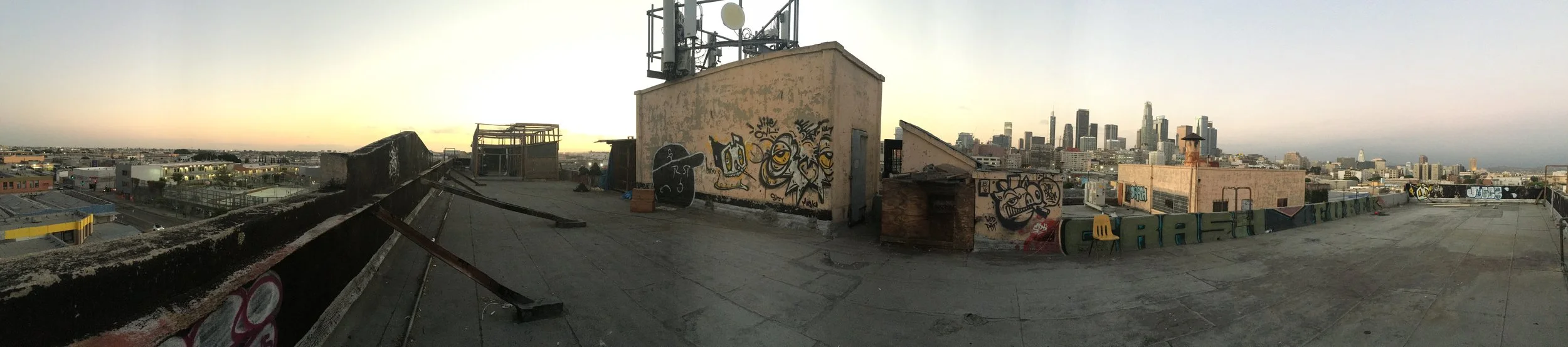 Roof top panorama. Nice view over down town. Note the pigeon cages to the left on the roof. Someone is raising pigeons here. For meat? Post?