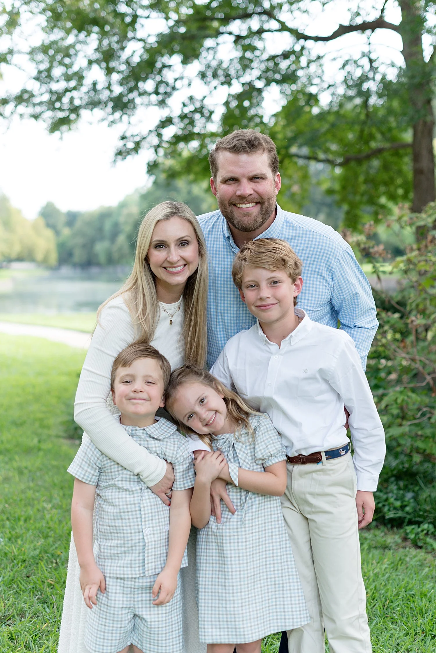 Family of 5 smiling for outdoor portrait by Dallas Family Photographer