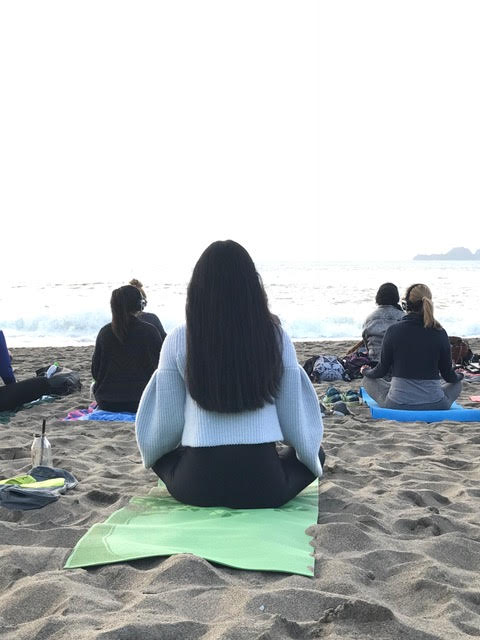 yoga student breathes in ocean air on bakers beach.jpg