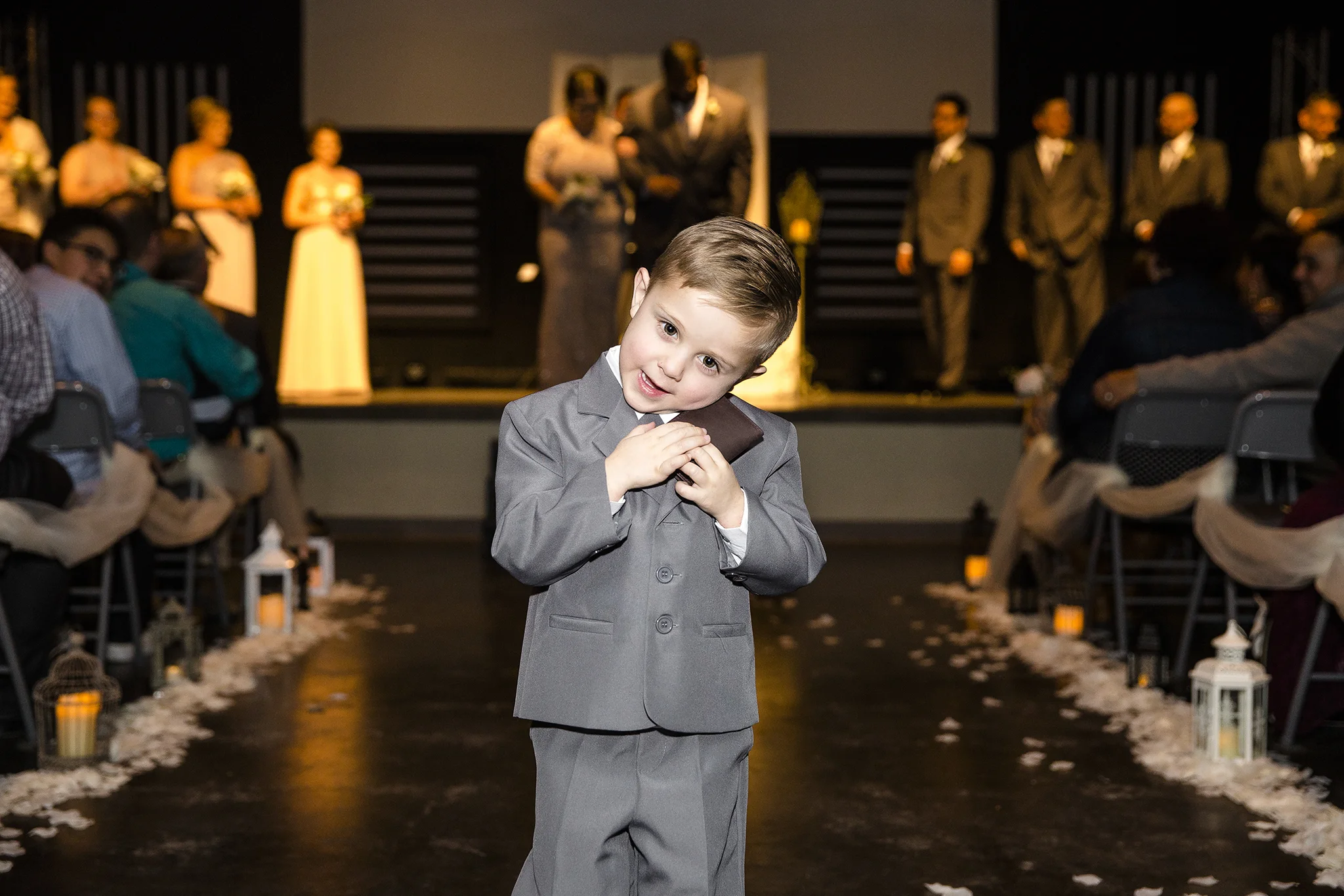 ring bearer holding his gift, cute moment, wedding ceremony