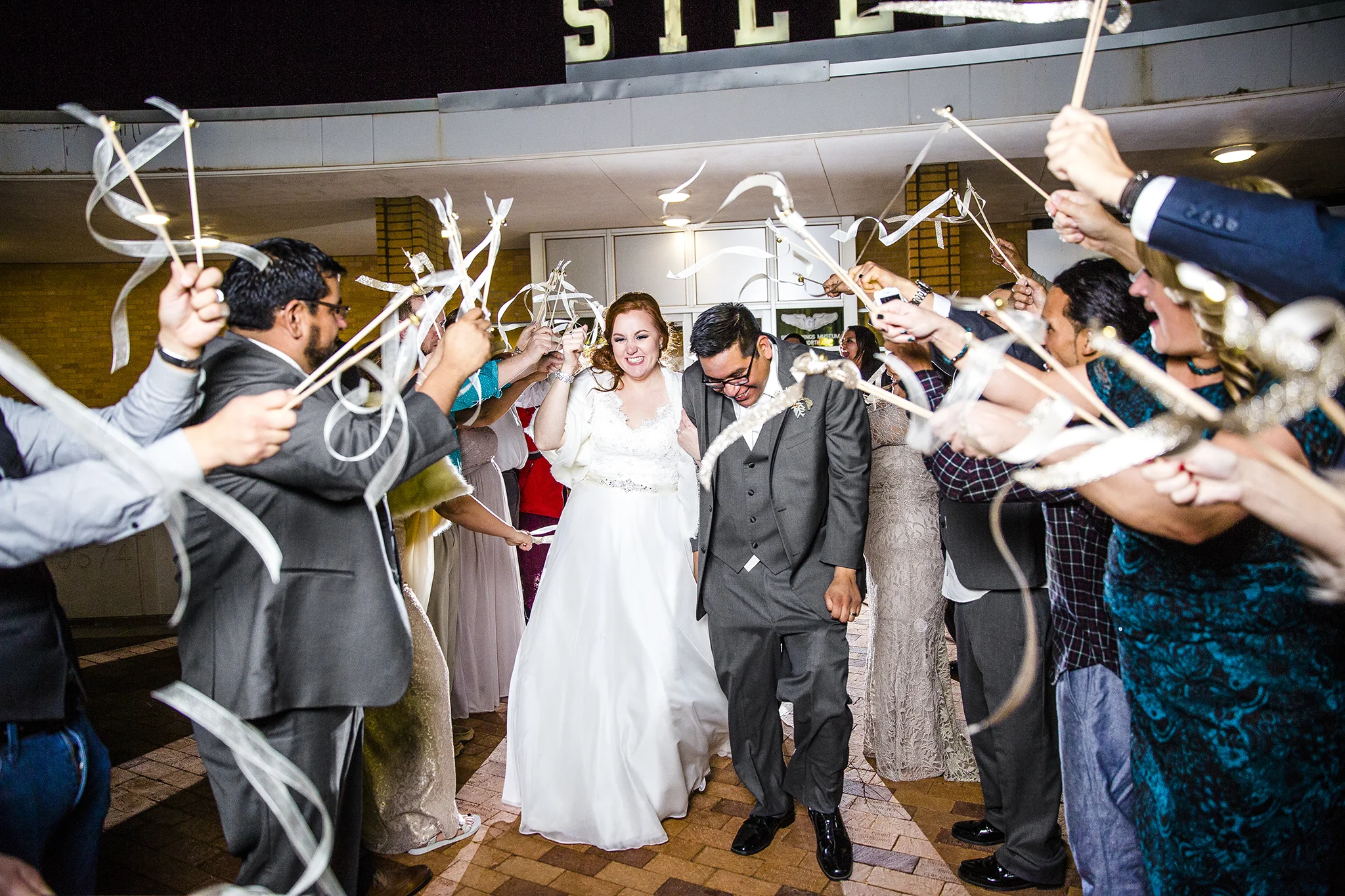 bride and groom, grand exit, ribbon wands, lubbock silent wings museum