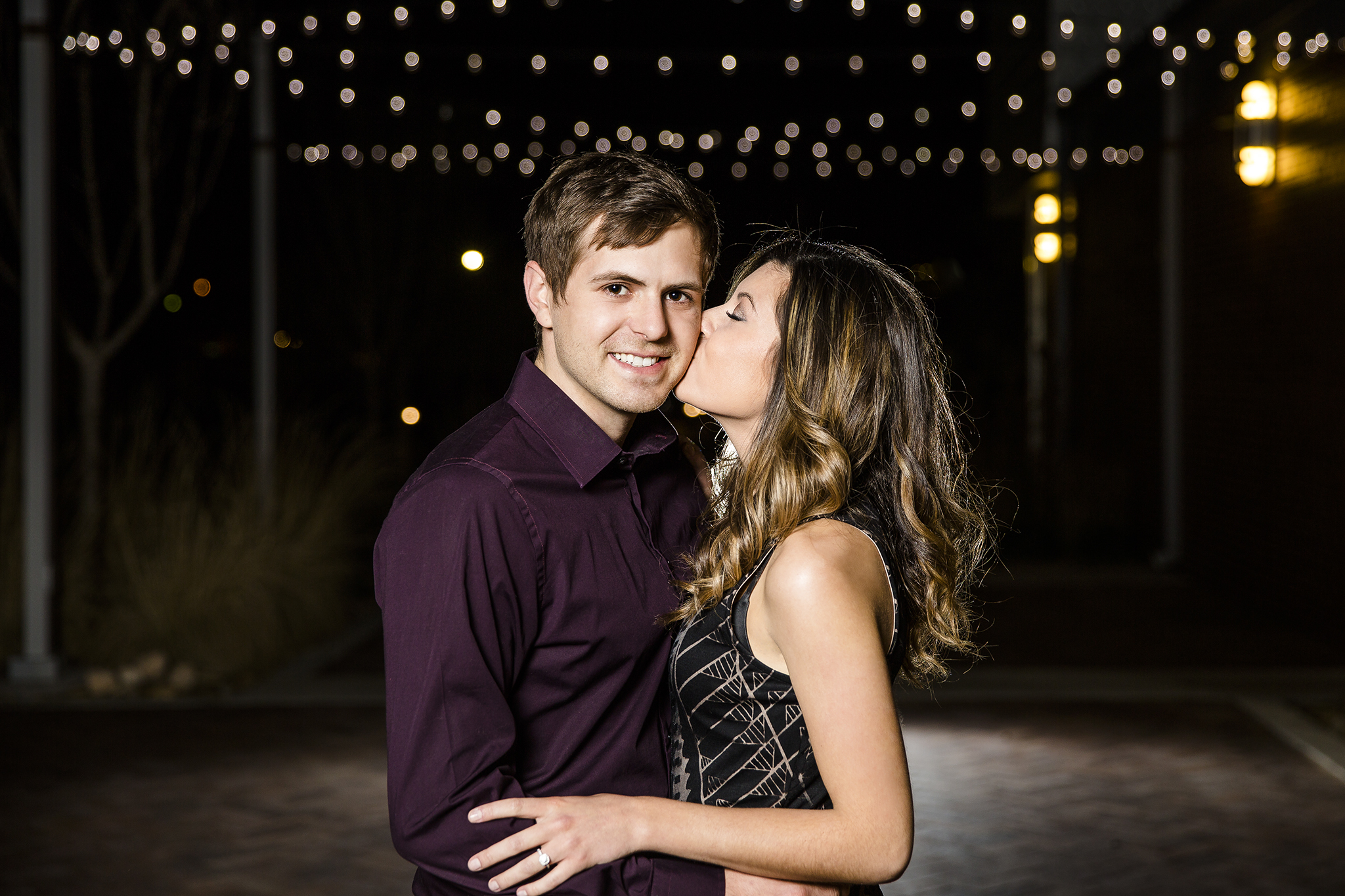 kissing, romantic, sweet engagement photos, soft light, downtown Lubbock, LHUCA building, bokeh