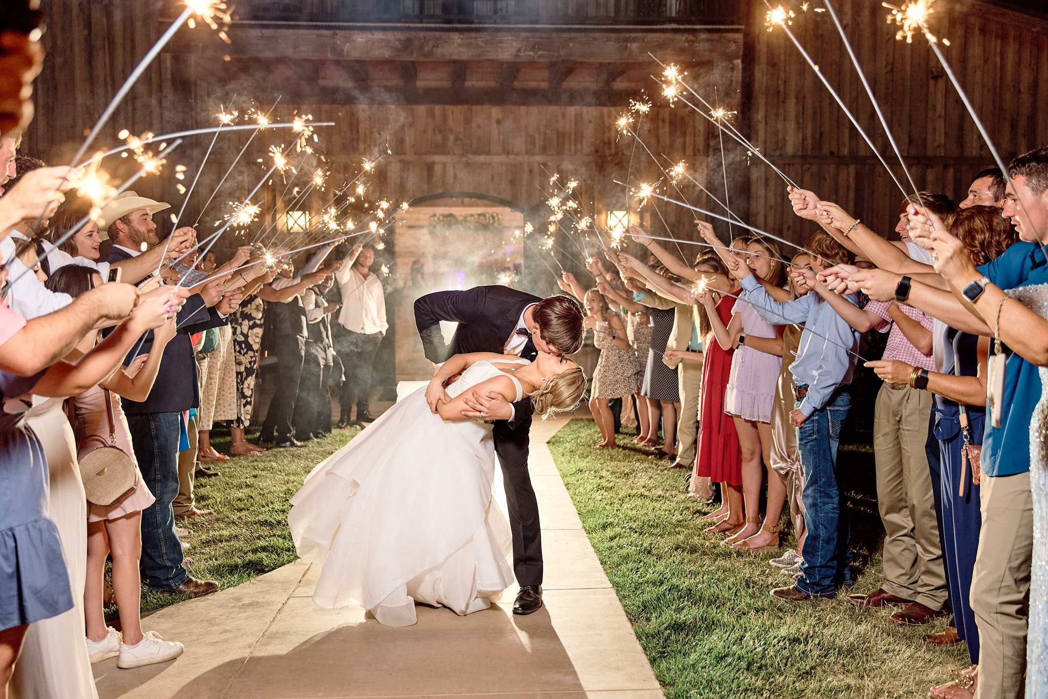 couple kisses during their wedding reception exit at eberley brooks events