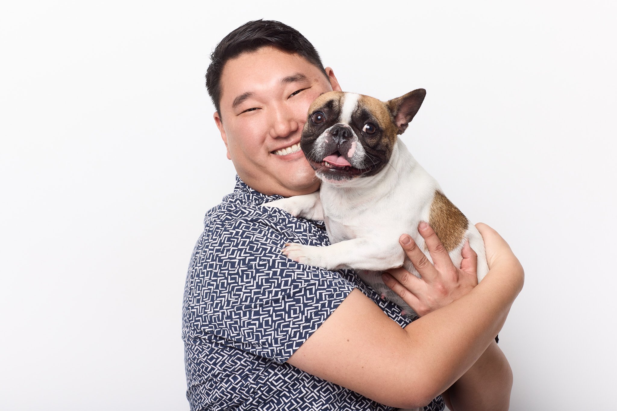 man poses with his dog for christmas photos