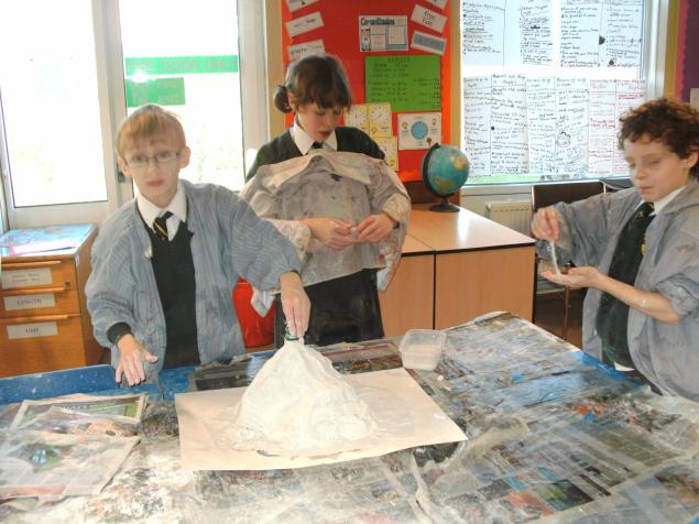  The final task of our active earth topic was to build models of volcanos which could be painted and then filled with vinegar and bicarbonate of soda to initiate volcanic eruptions. Particularly enjoyable was applying modroc to the models - a rather 