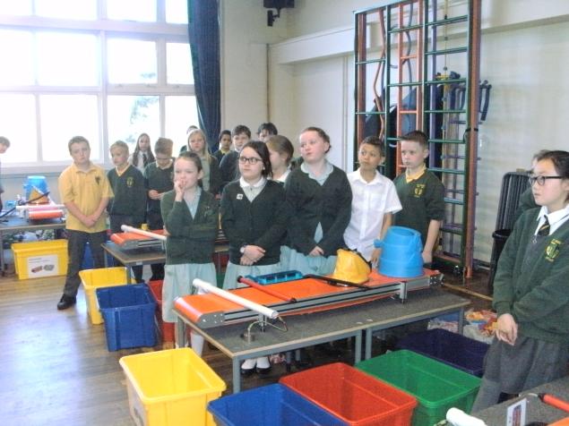  The children stand by their conveyor belts before the sorting begins! 