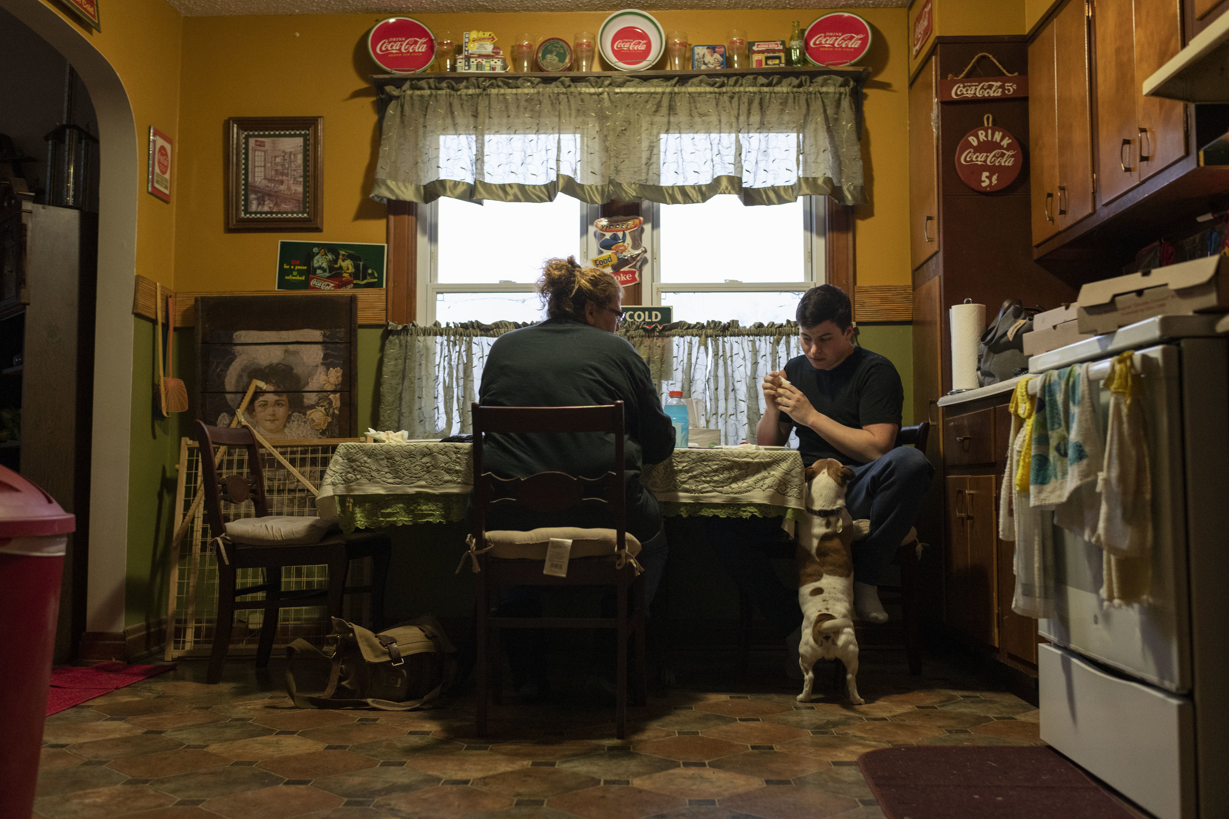  Todd and his mom Lori Mckenzie eat dinner together at the kitchen table. Todd’s stepdad eats dinner in his recliner in the living room on Friday, November 30, 2018. 