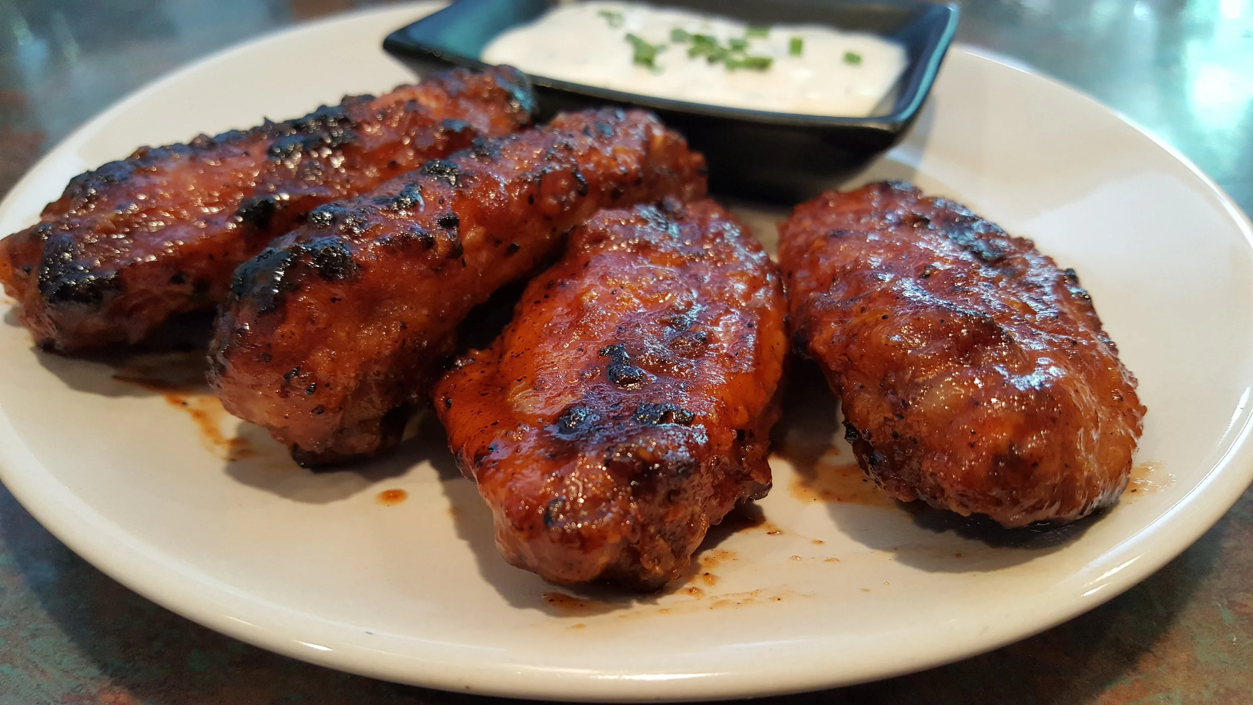 Equal parts Sriracha & Honey for a wing delivering hefty doses of both heat and sweet. I call them "Diablo Kisses."