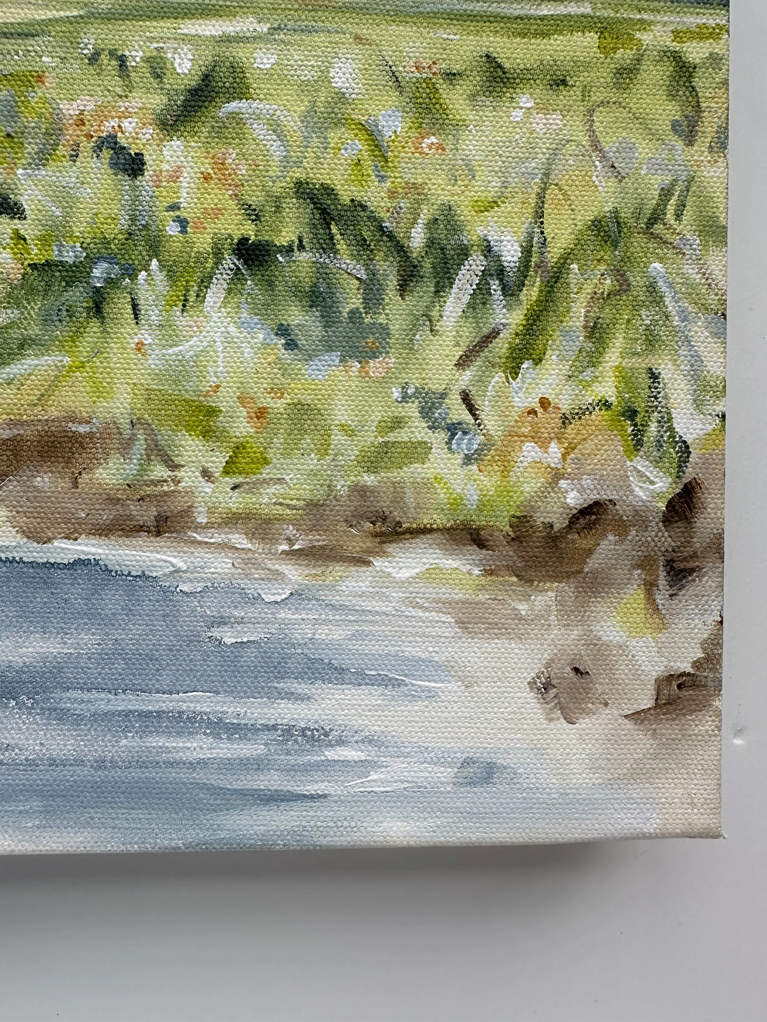 Horizontal original landscape painting with calm blue water and green shoreline