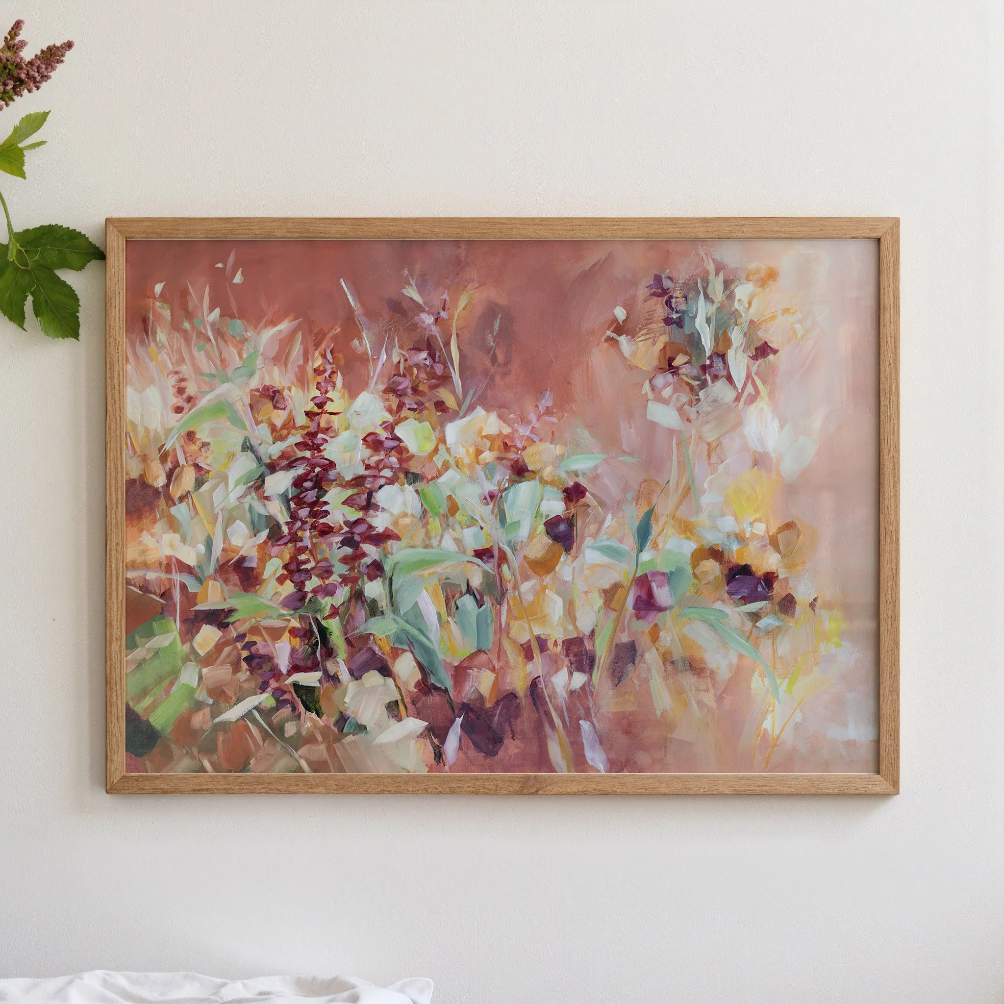 Framed abstract floral fine art print by Kendra Castillo displayed on a neutral wall in a light wood frame.
