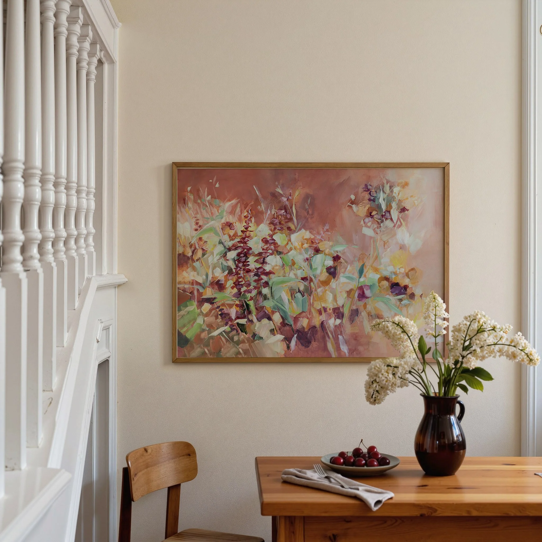 Large framed abstract floral print by Kendra Castillo displayed above a dining table in a warm, inviting interior.