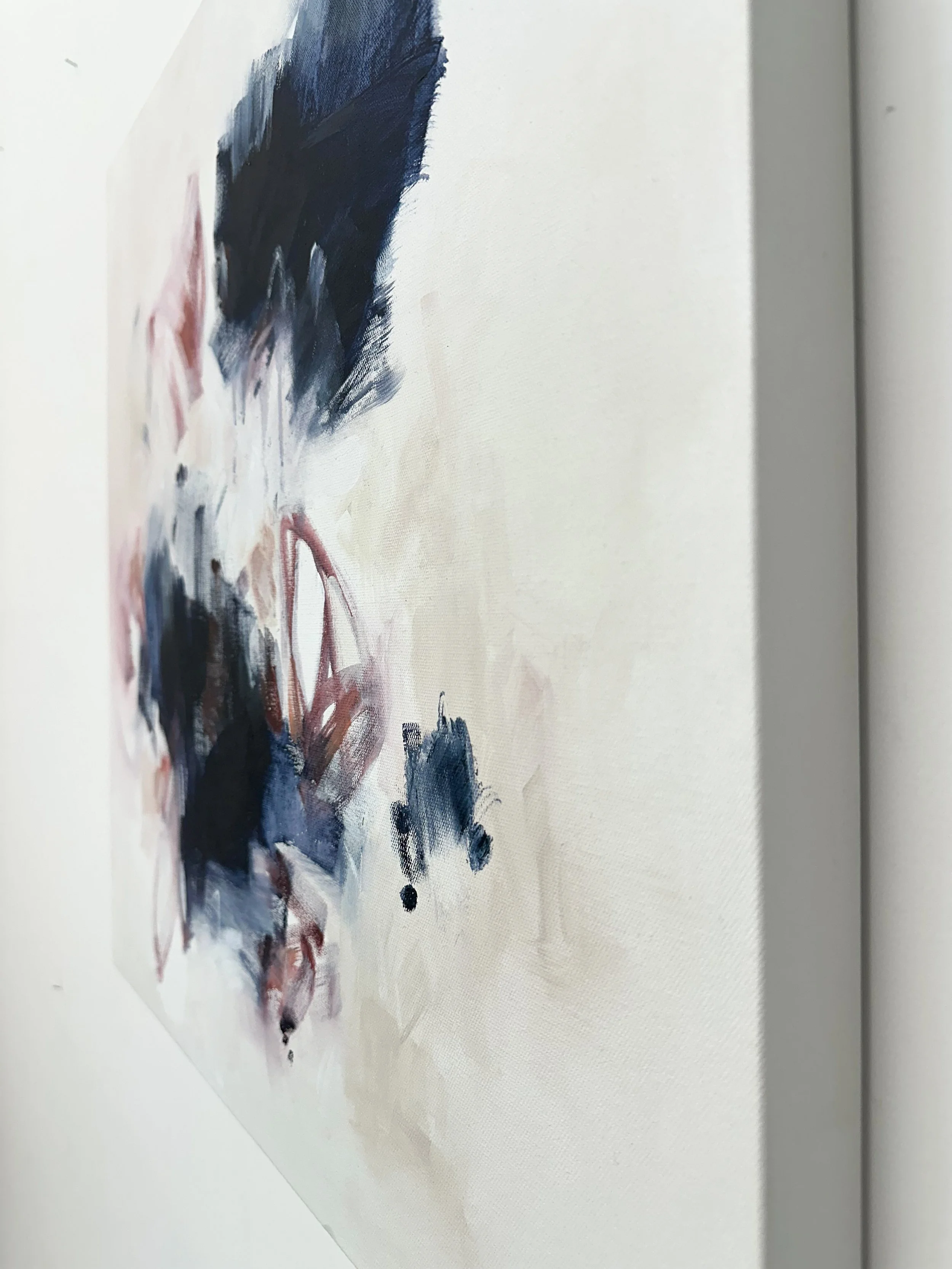 Original 24x24 abstract wall art by Pacific Northwest artist Kendra Castillo with airy white space, deep navy marks, and soft pink accents.