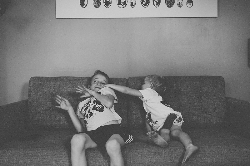 two boys playing on couch
