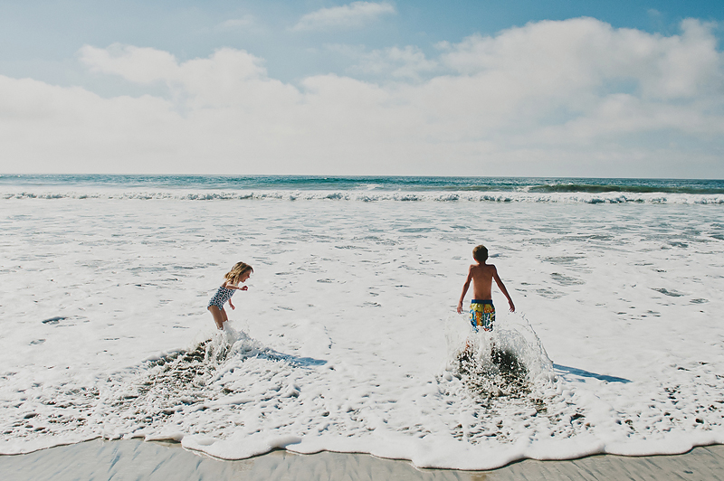 kids playing in ocean at beach