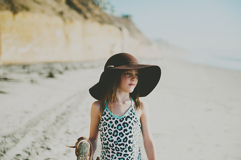 little girl wearing floppy hand on sandy California beach