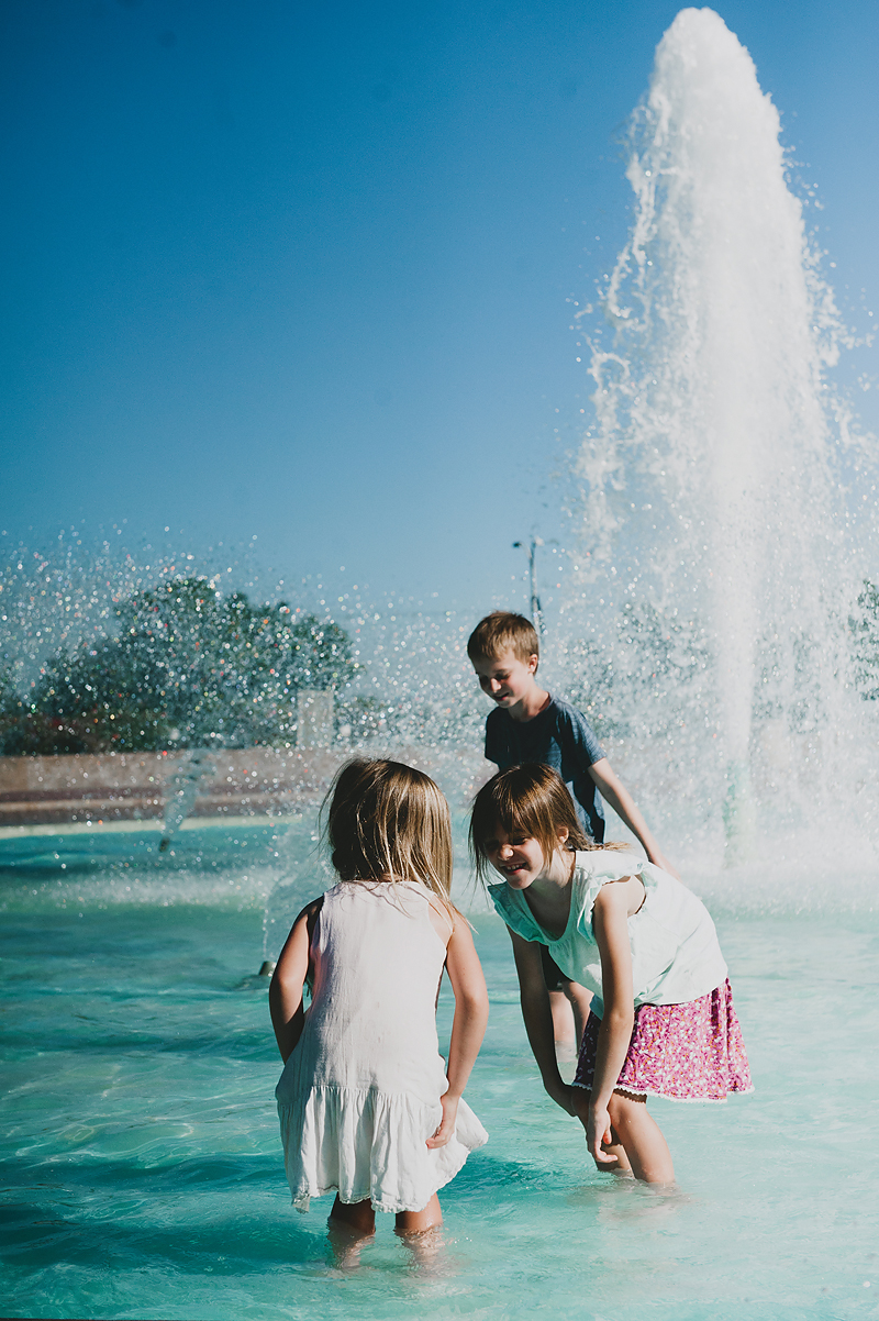 girls and boy playing in fountain at balboa park