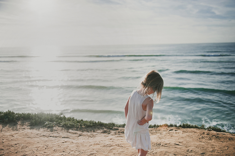 little girl standing on beach overlook in California