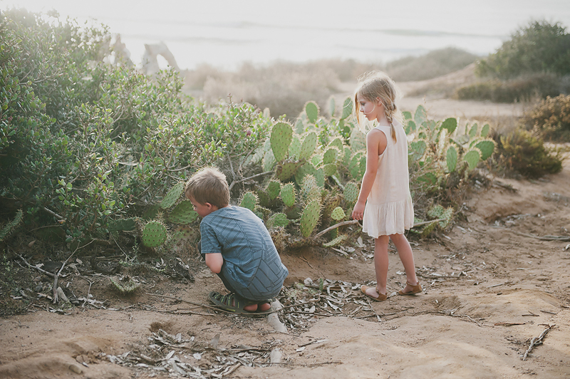 boy and girl in front of cactus cacti on California beach