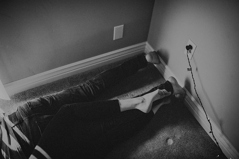 Couple snuggling on floor, feet together