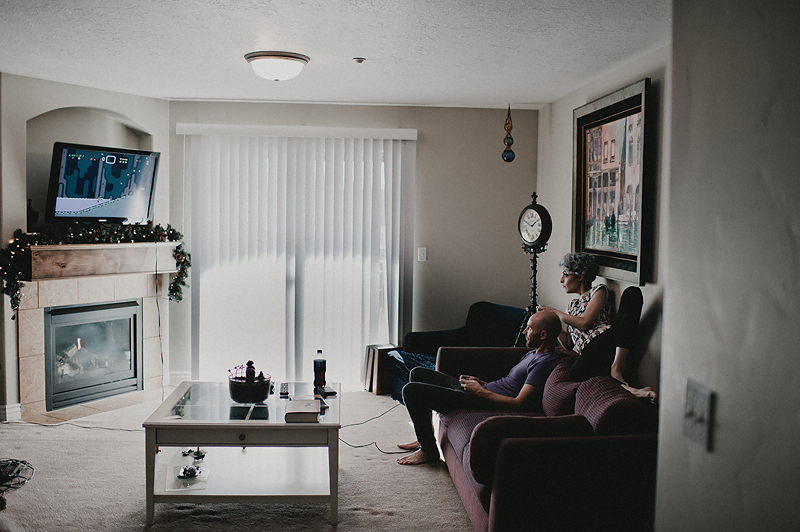 Couple sitting on couch playing video games together