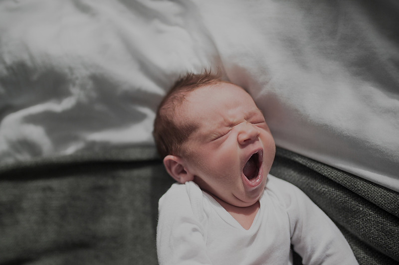 Newborn baby boy yawning