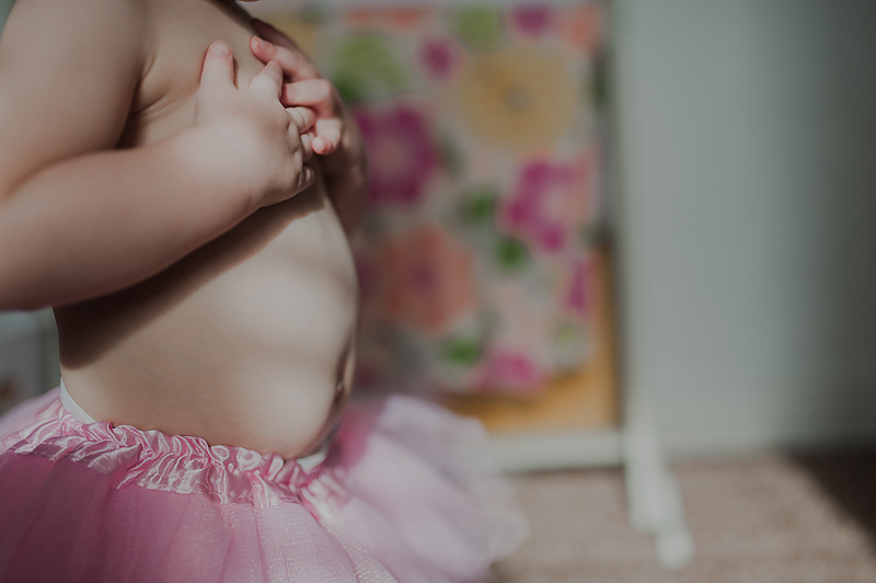 One year old baby girl tummy wearing tutu
