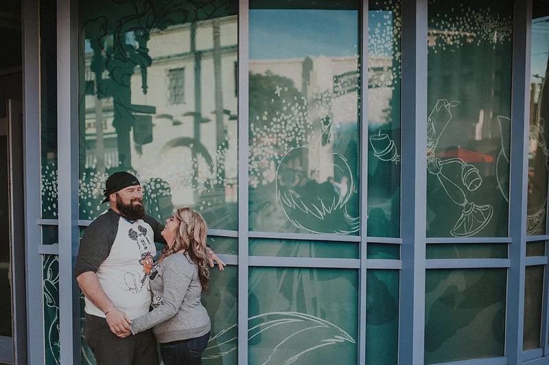 Couple laughing together in front of animation building at disneyland california adventure