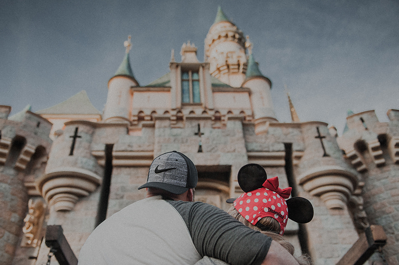 Couple looking up at Disneyland castle at Disneyland theme park