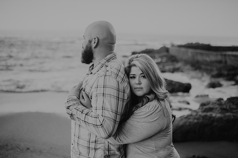 Couple leaning together on beach in California