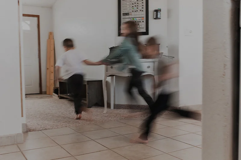 Kids running through house playing together
