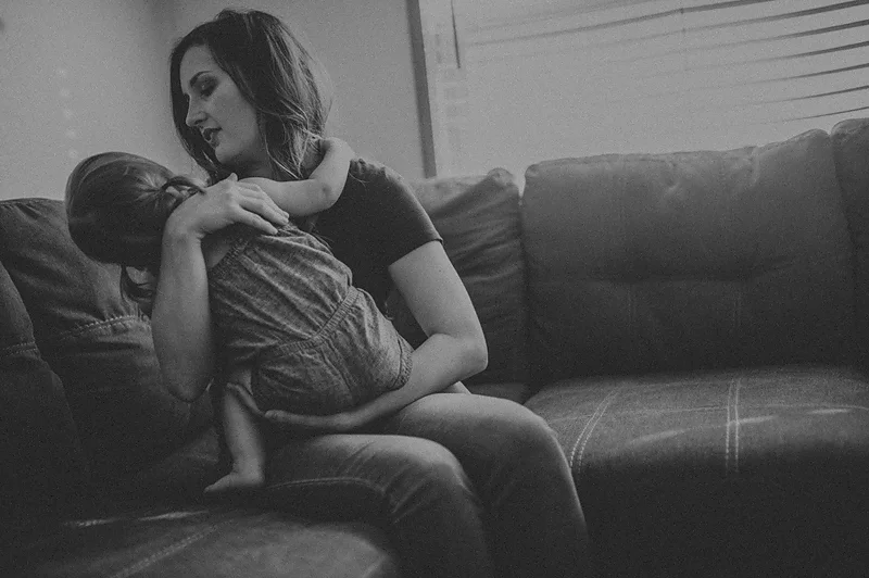 Mom snuggling and comforting baby girl