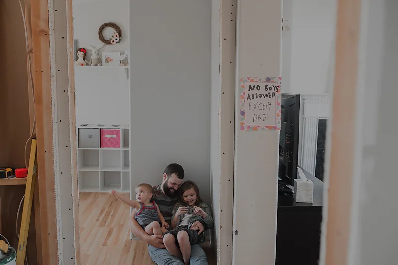 Dad playing with girls in their bedroom