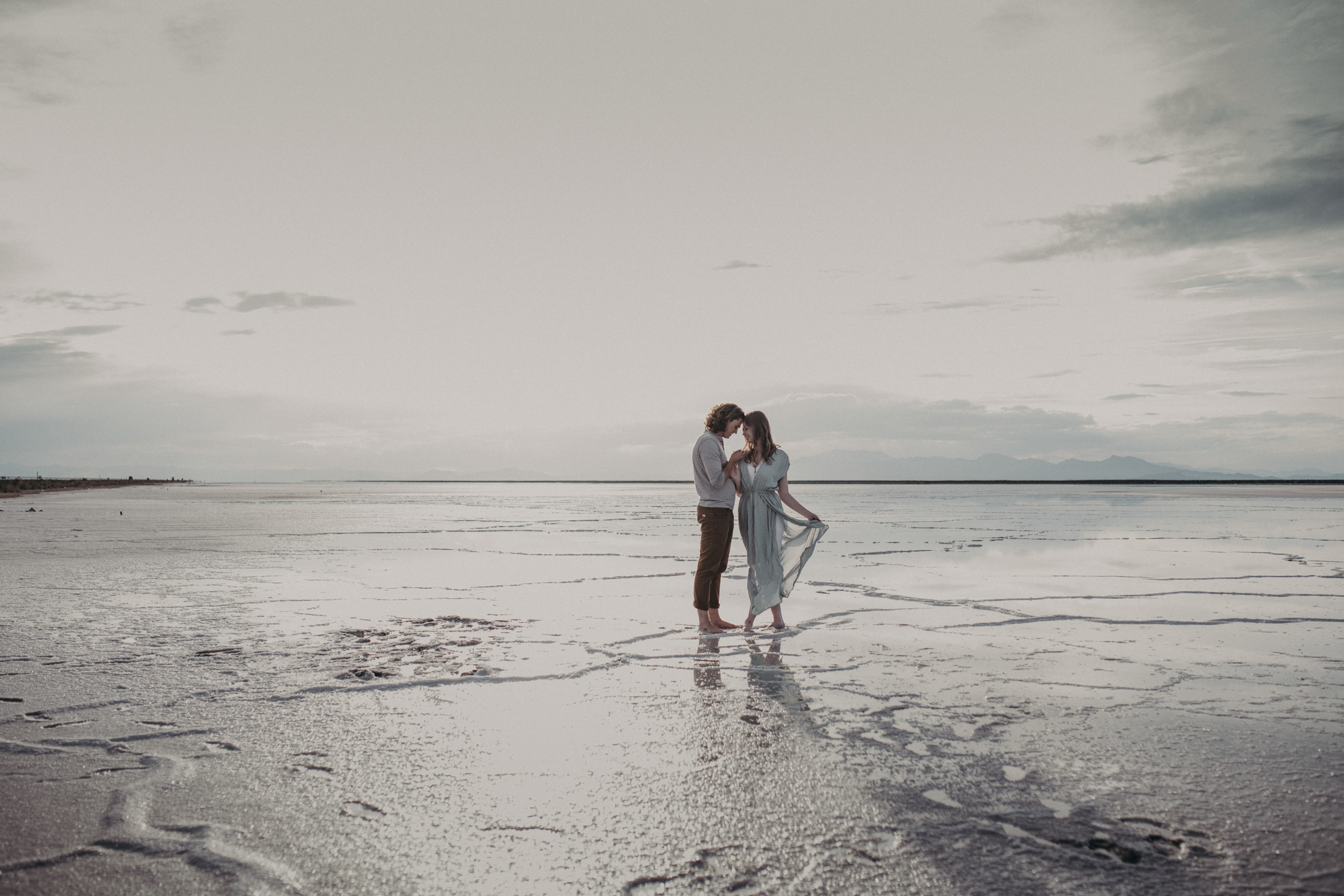 Couple holding hands on the salt flats