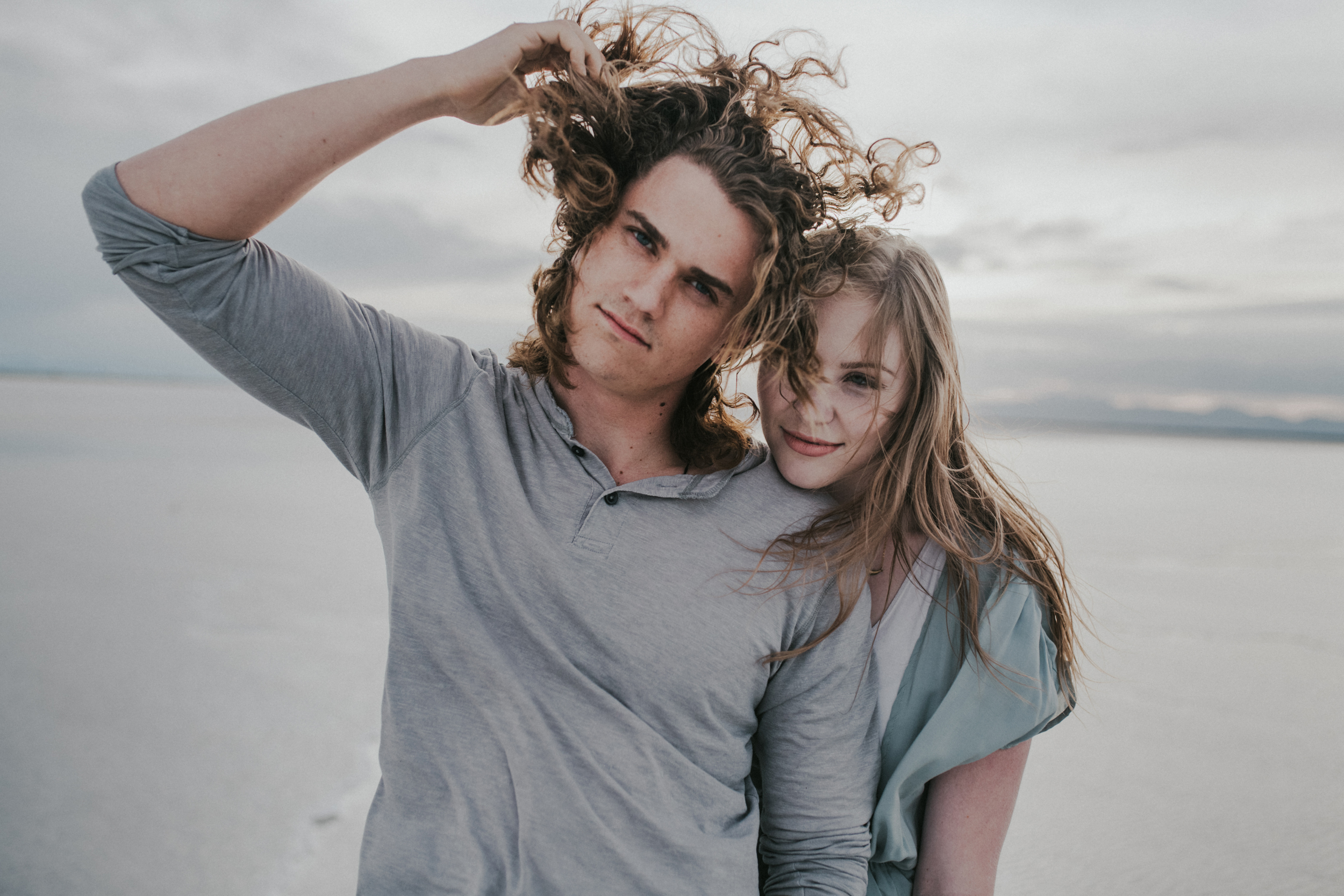 Guy with long hair with girl at the salt flats