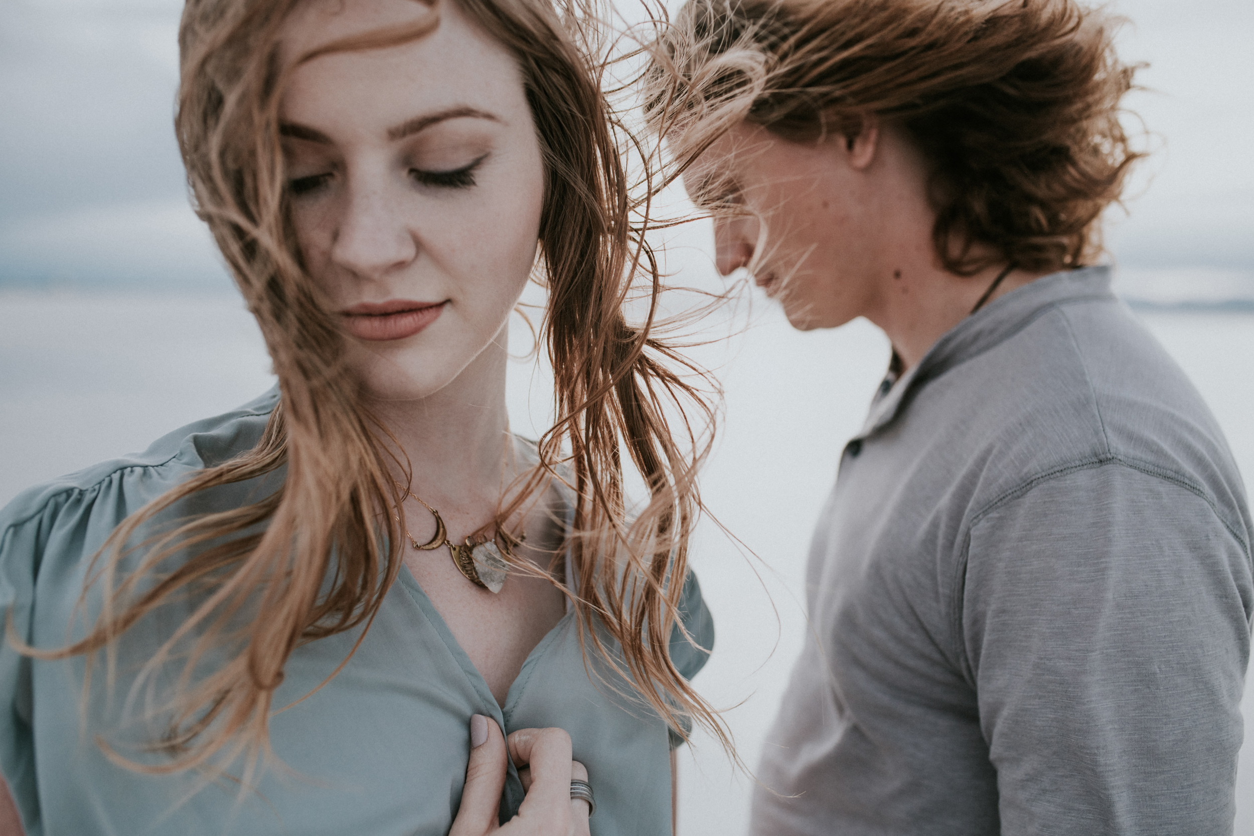 Couple at the salt flats wind blowing through their hair