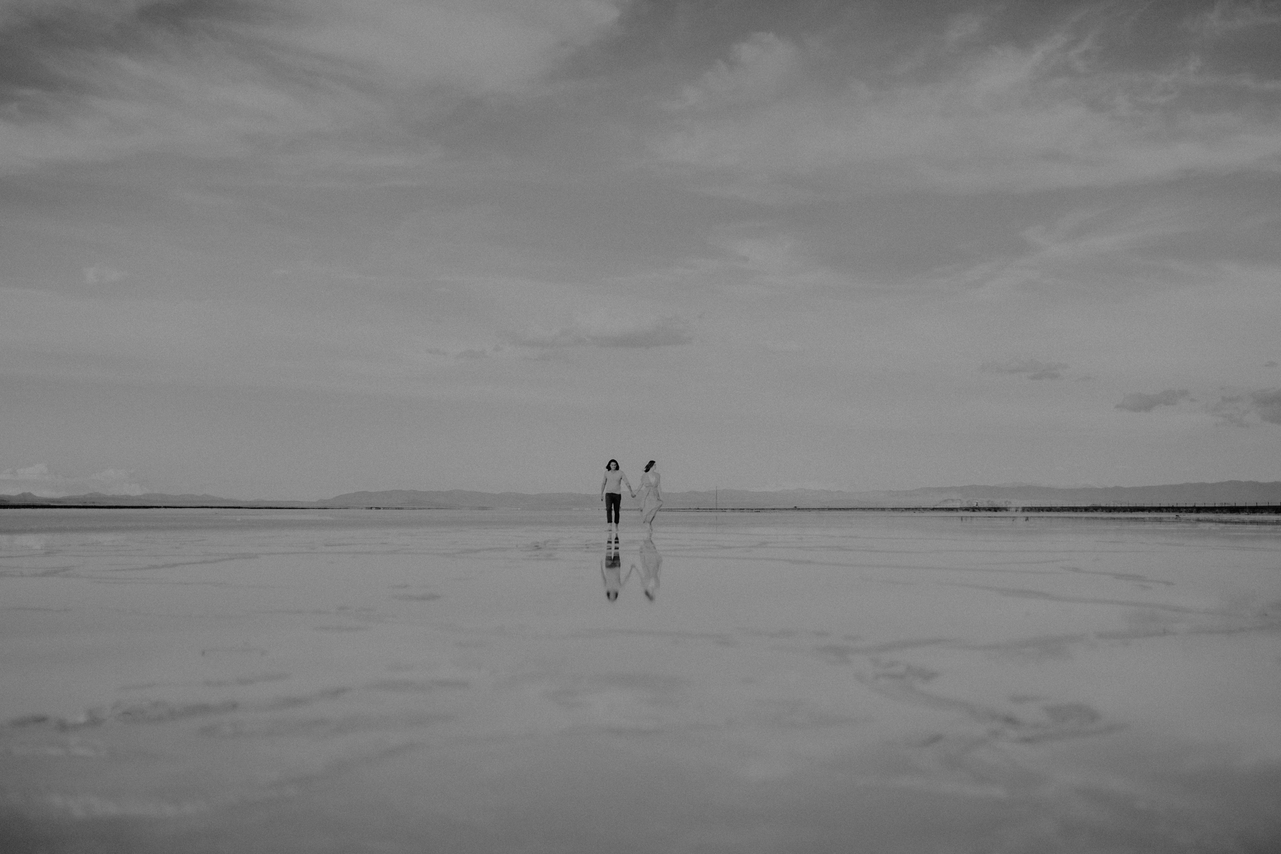 Couple  hand in hand on the salt flats