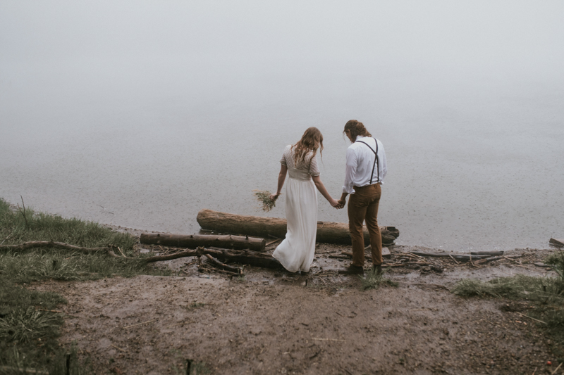 Couple in wedding gown and suspenders on lake