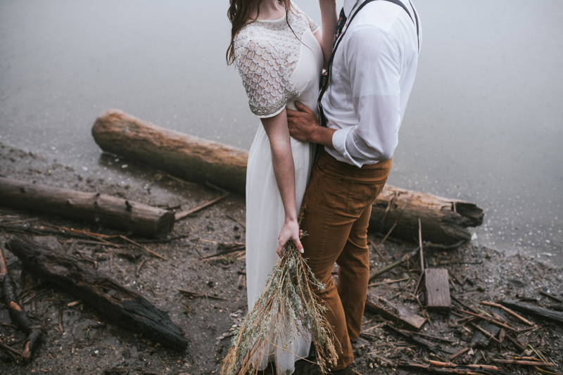 Lakeside elopement of bridal couple with sagebrush bouquet