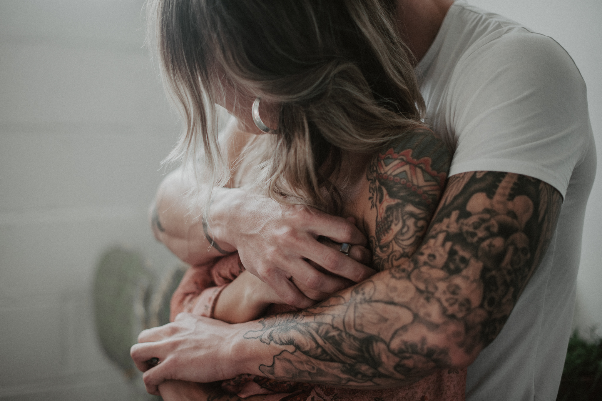 Tattooed Couple wrapping arms around each other