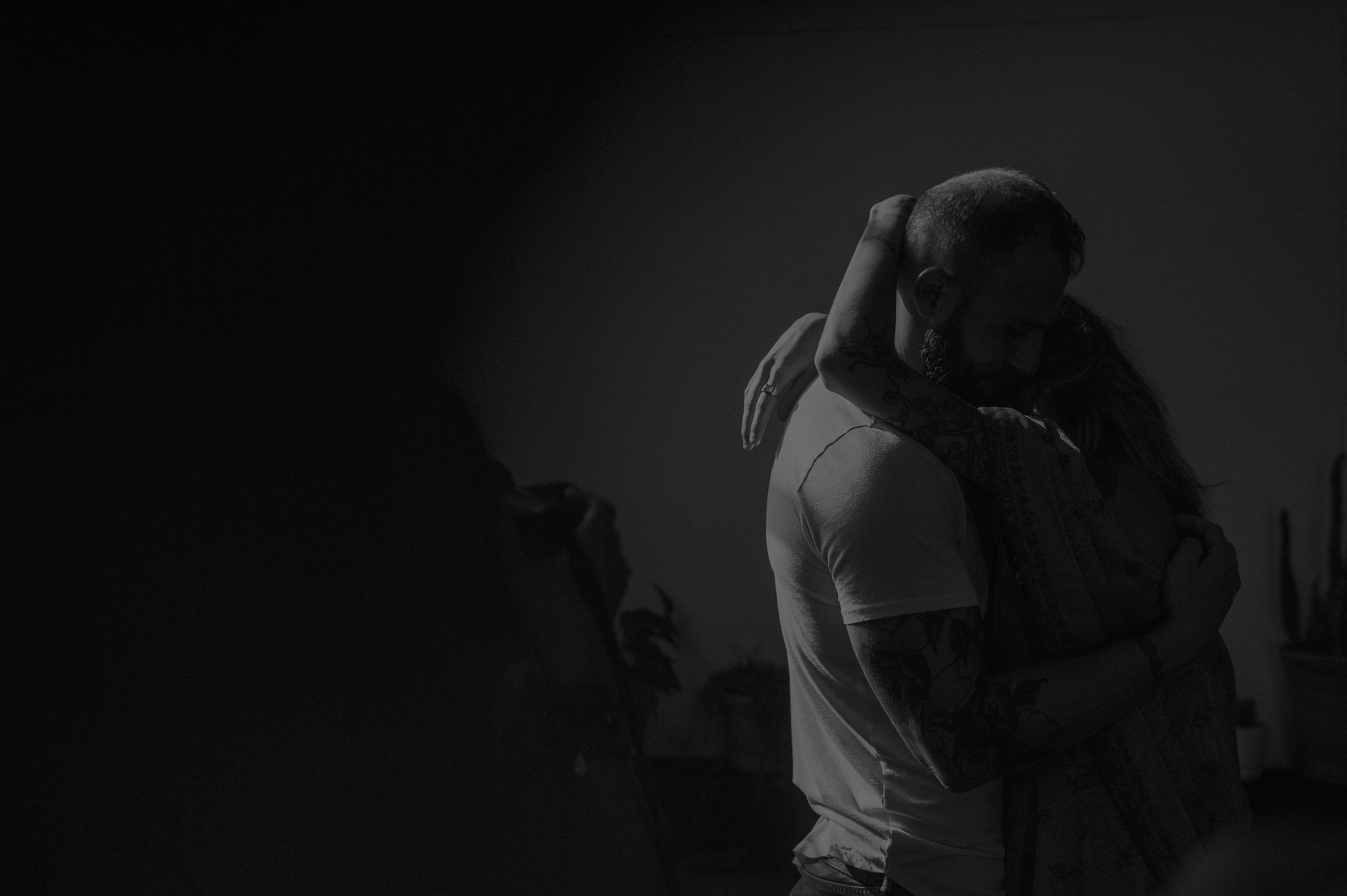 Moody black and white of couple hugging