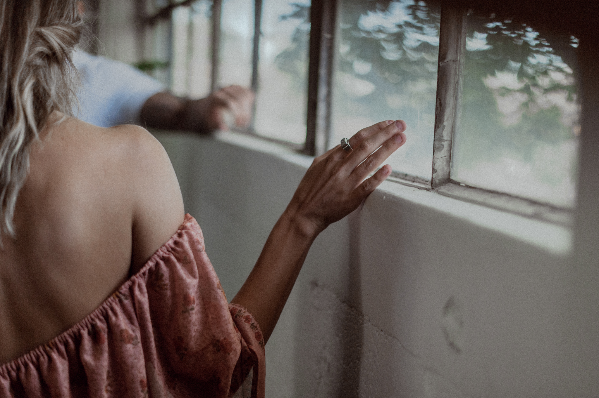Girls hand running along window