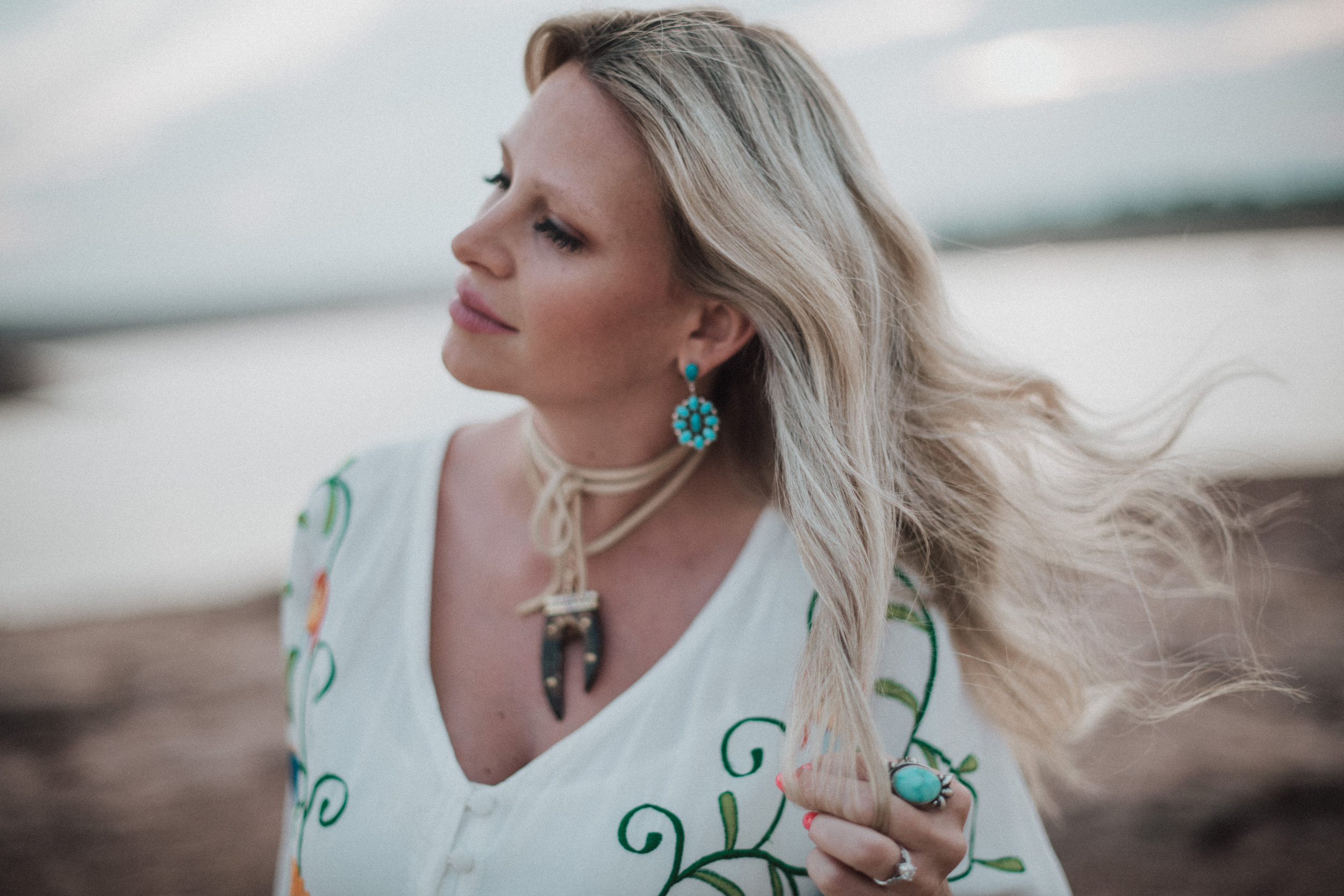 turquoise tribal jewelry blonde hair blowing in the wind