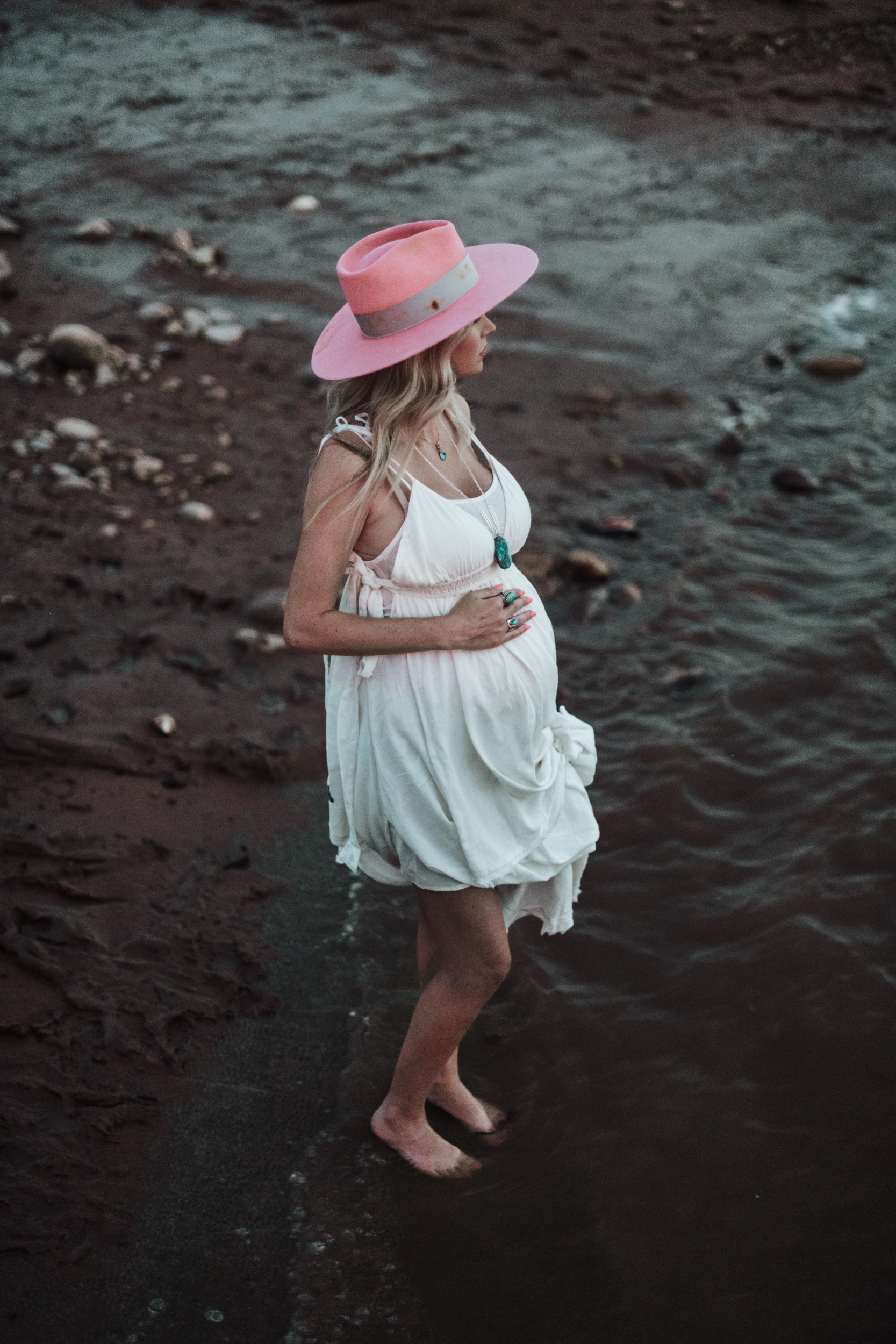 Pregnant mom on beach wearing pink cowboy hat cowgirl Lady War Bonnets